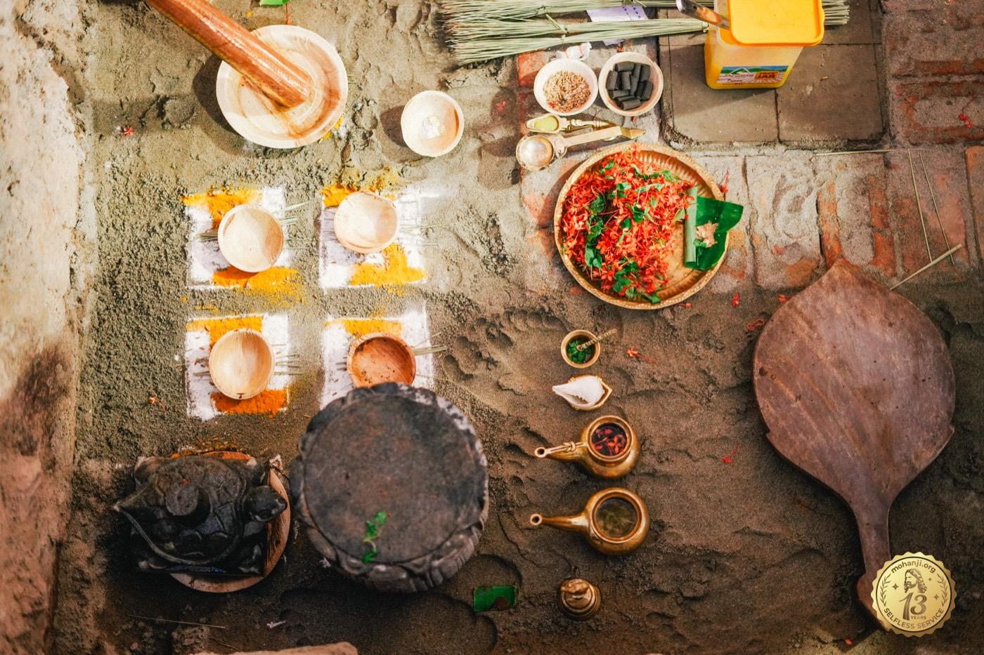Vedic ritual offerings — coconut, kumkum, flowers, brass vessels — laid out for ceremony